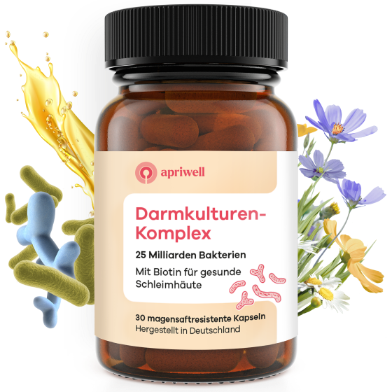 Eine braune Flasche Darmkulturen-Komplex. Auf dem Etikett stehen 'apriwell Darmkulturen-Komplex', '25 Milliarden Bakterien', 'Mit Biotin für gesunde Schleimhäute', '30 magensaftresistente Kapseln' und 'Hergestellt in Deutschland'. Um die Flasche herum sind stilisierte Bakterien, Blüten und eine goldene Flüssigkeit zu sehen.